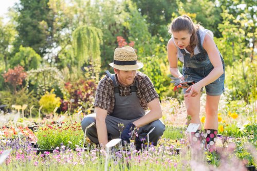 Gardener discussing garden work with homeowner before maintenance