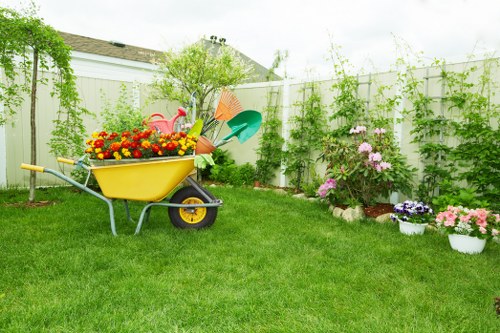 Raised garden beds with wide paths and seating designed for accessibility in Thamesmead community garden