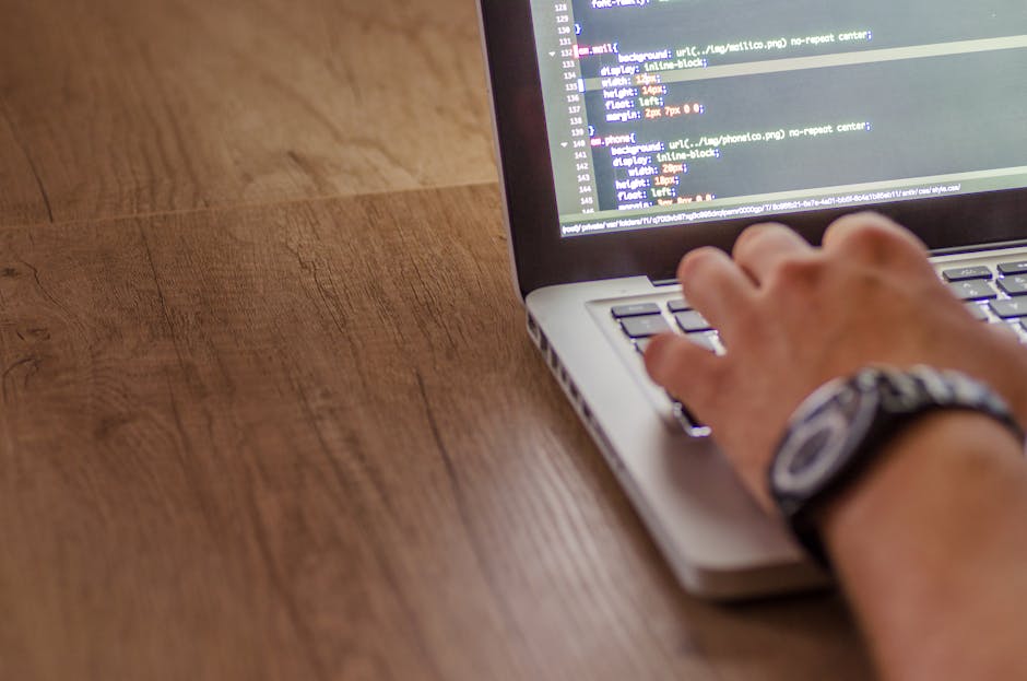 A digital screen displaying lines of colored code in a programming language, with syntax highlighting in shades of green, yellow, purple, and blue against a dark background. The code includes CSS styl